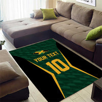Green cricket area rug with gold 10, black sides, and 'YOUR TEXT' centered under sofa