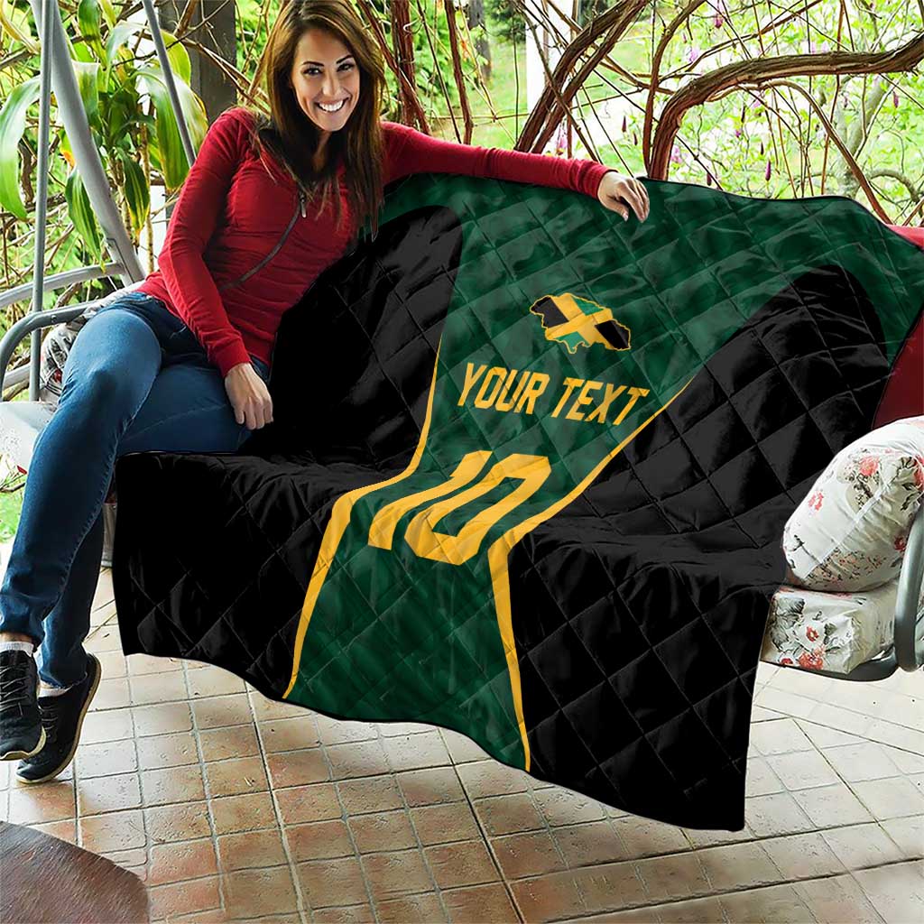 Custom quilt blanket draped over couch: green jersey, black quilt, yellow 10, and 'Your Text'