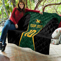 Custom quilt blanket draped over couch: green jersey, black quilt, yellow 10, and 'Your Text'