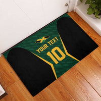 Green rubber cricket jersey doormat laid on floor with black sides and gold “10” graphic