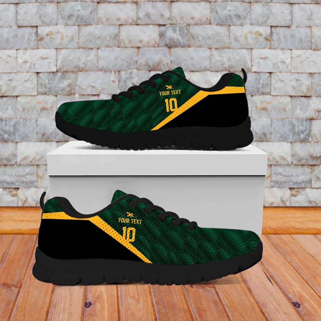 Green lace-up sneakers with black sole and yellow stripe, on display
