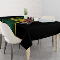 Green and black cricket tablecloth with gold trim, hanging over table corners