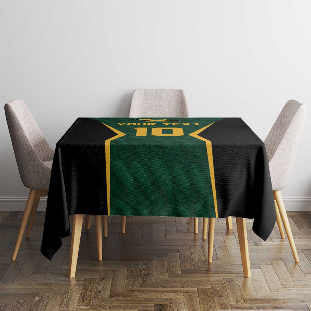 Green, black and gold cricket tablecloth with printed text and number on table