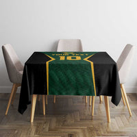 Green, black and gold cricket tablecloth with printed text and number on table