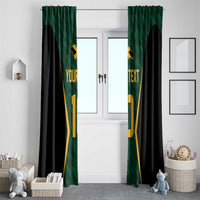 Green and black window curtains with gold cricket jersey print, hanging on a door window
