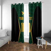 Green and black custom window curtains with gold jersey print, hanging on a white rod