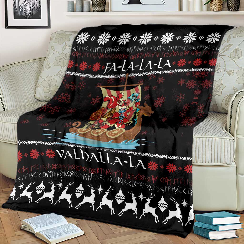 Black throw blanket on an armchair with Viking Santa warrior, snowflake pattern, and Valhalla-La