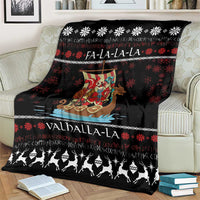 Black throw blanket on an armchair with Viking Santa warrior, snowflake pattern, and Valhalla-La