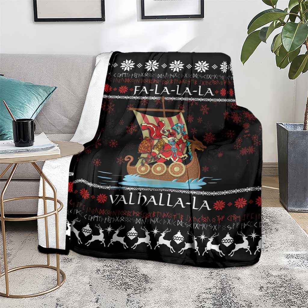 Black Christmas blanket on a living room chair, showing Viking Santa warrior and snowflake design