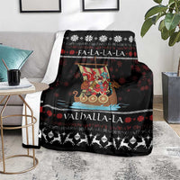 Black Christmas blanket on a living room chair, showing Viking Santa warrior and snowflake design