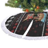 Black Christmas tree skirt laid flat with white fringe border and colorful Viking ship graphic