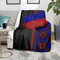 Black, blue, and red seamless patterned throw blanket on a living room sofa
