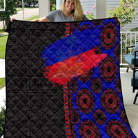 African flag-style quilt in black with blue and red paisley ring motifs, quilted