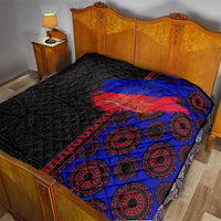 African flag-style quilt on bedspread, black with blue and red ring medallion pattern