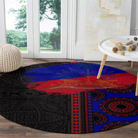 Round area rug with black base and red-blue oval tribal medallion pattern