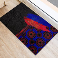 Rubber doormat featuring black ornate pattern and blue/red graphic with red circular details