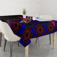 Tablecloth with blue, red, and black ornate seamless pattern covering tabletop