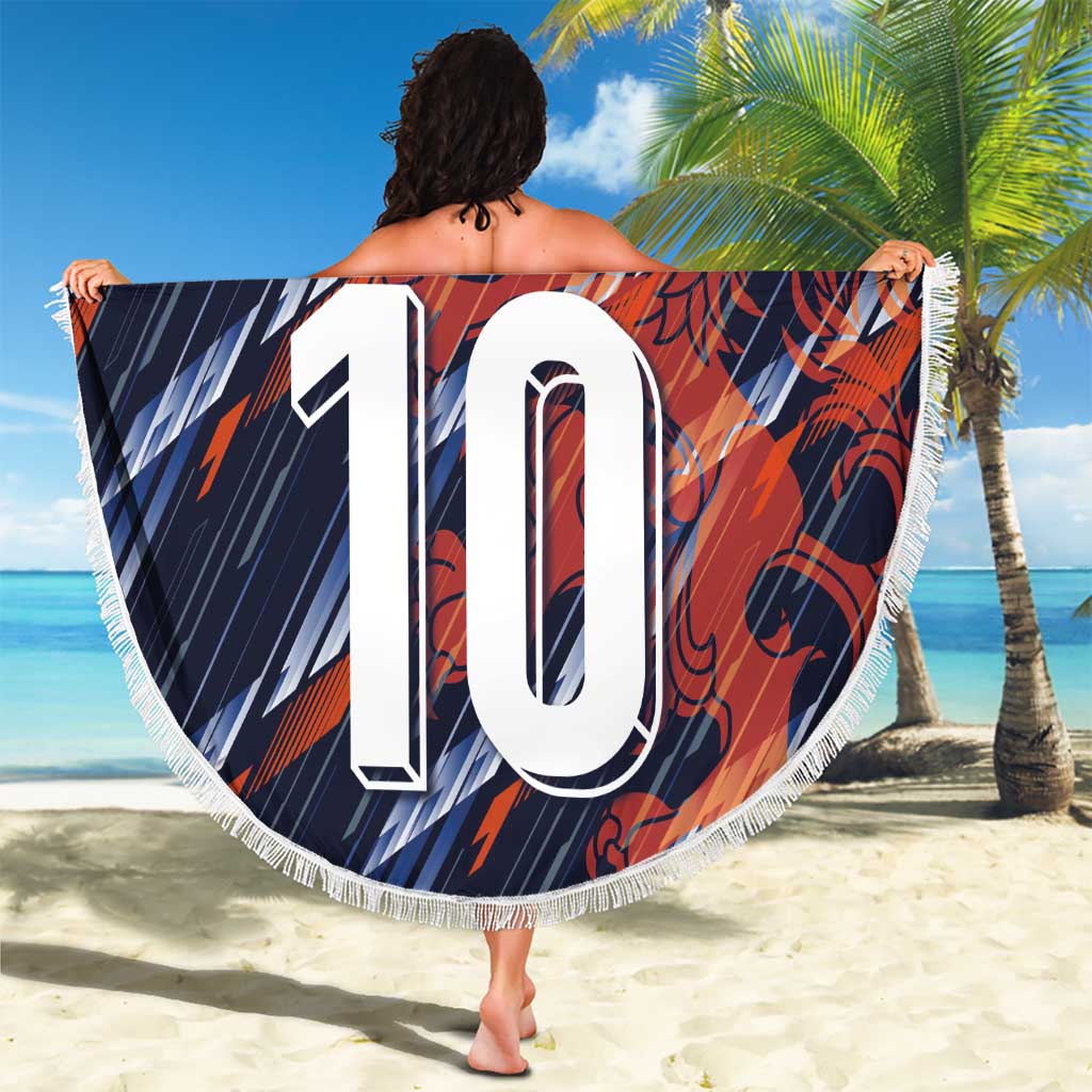 Navy circular fringe beach blanket with crest and “YOUR TEXT” over large “10” on beach