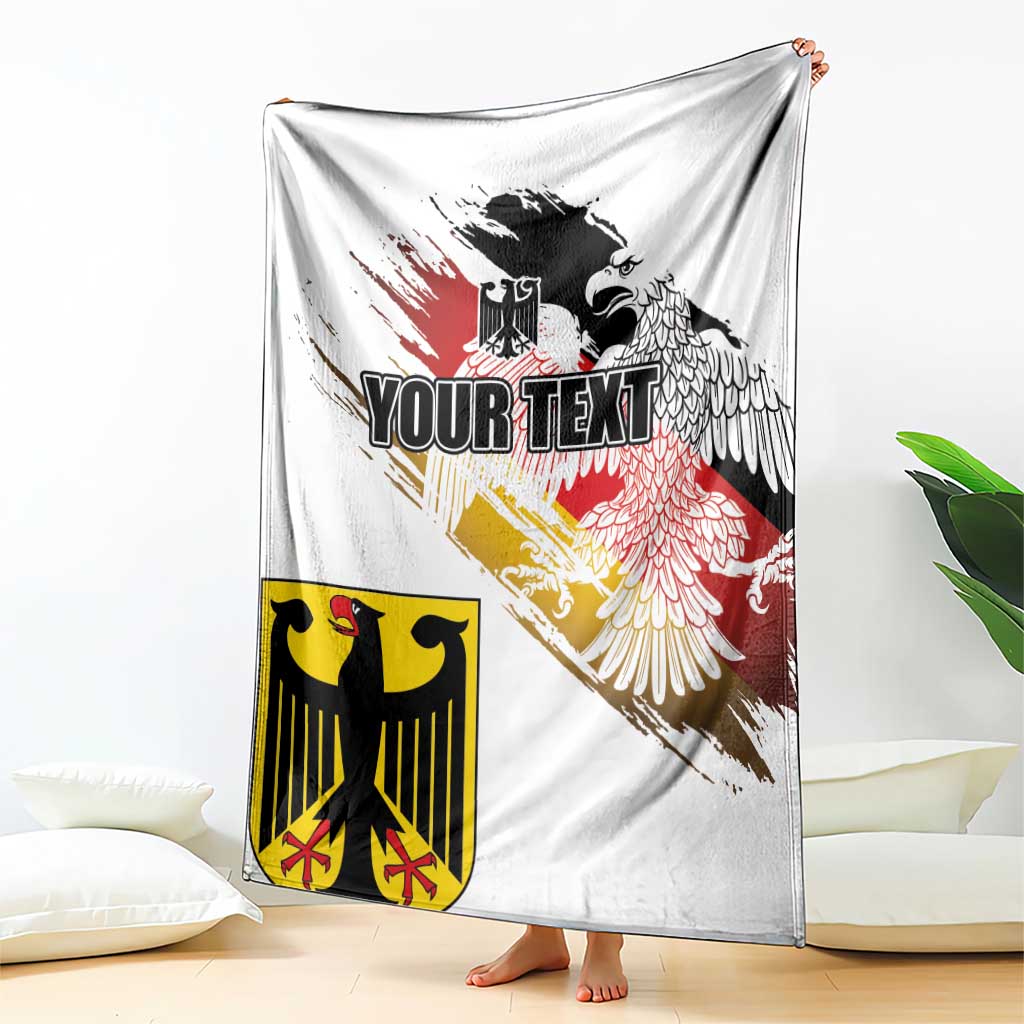 White blanket draped over bed, showing black eagle crest with red-yellow grunge flag print.