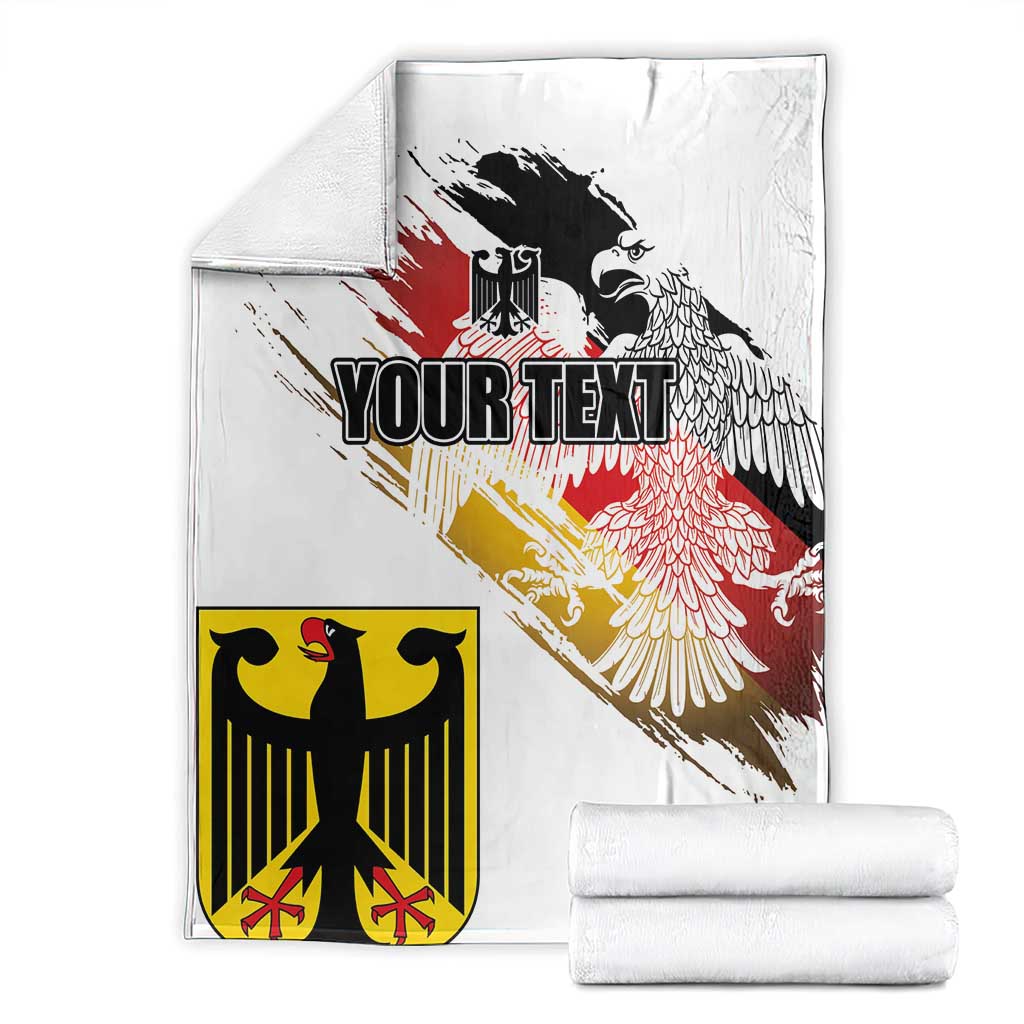White folded blanket stacks with black eagle crest and red-yellow grunge flag; 'YOUR TEXT'.