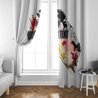 White window curtain pair with German eagle seal grunge print and custom text, hanging on window