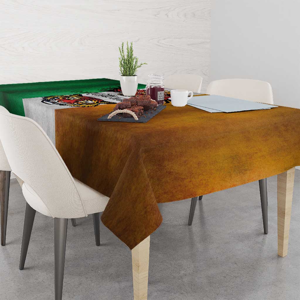 Rectangular grunge tablecloth on table; green-and-brown color blocks with gray center graphic