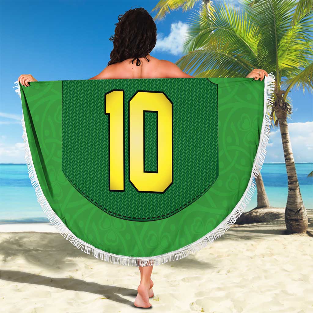 Green round beach blanket with fringe, large number 10 jersey design held on beach
