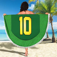 Green round beach blanket with fringe, large number 10 jersey design held on beach