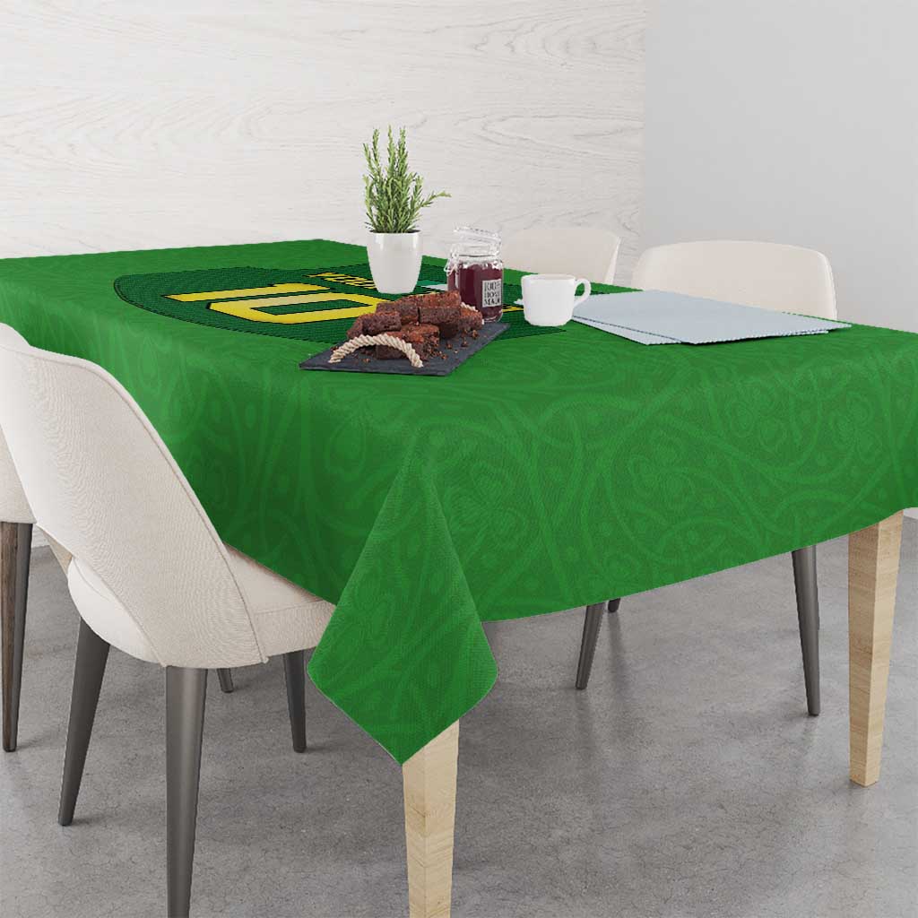 Green rugby-style tablecloth with number graphic and tea set on tabletop
