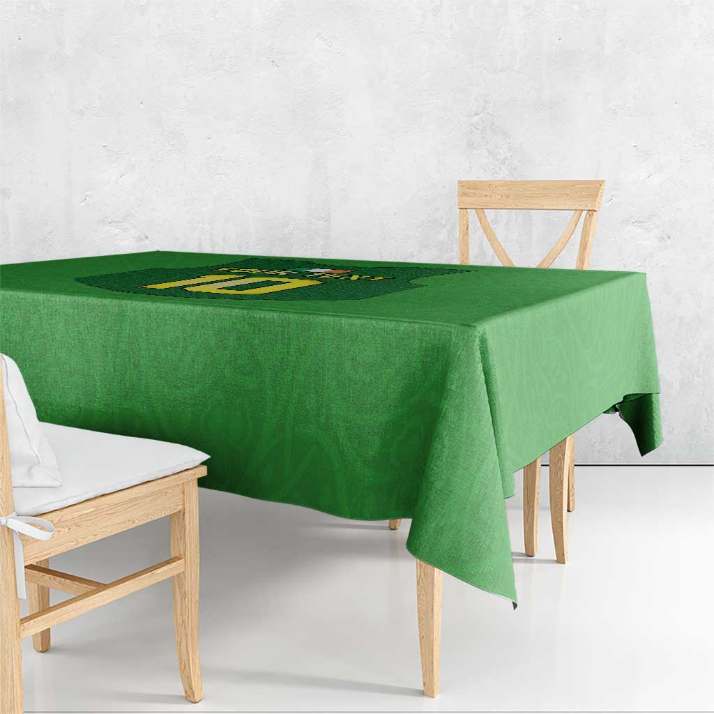 Green tablecloth with rugby-style gilet number emblem, draped over table edge