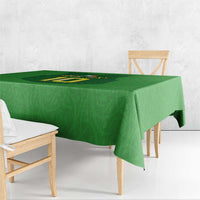 Green tablecloth with rugby-style gilet number emblem, draped over table edge