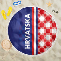Round beach blanket with blue and red checker panels, vertical stripe, white fringe