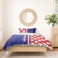 Blue duvet and pillows with red-and-white checkerboard design and striped HRVATSKA detail.