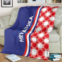 Blue and red checkered throw blanket draped on a sofa with "HRVATSKA" text