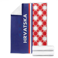 Folded blue and red checkerboard blanket with white stripe and "HRVATSKA" text