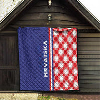 Blue and red check quilt hanging on a wooden wall with HRVATSKA stripe