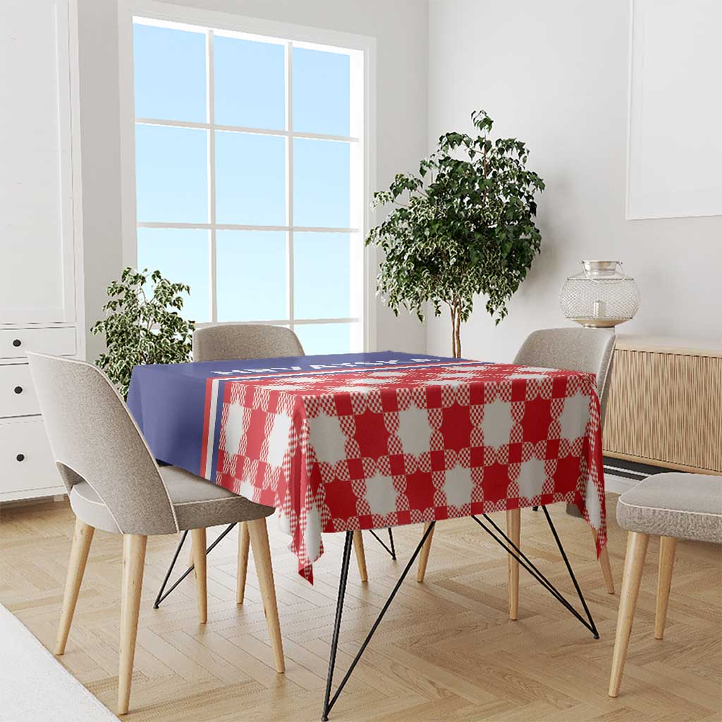 Red checkered tablecloth with blue edge stripe, covering dining table with chairs