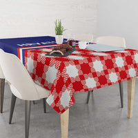 Red and white checkerboard tablecloth with blue stripe panel, draped on dining table