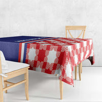 Red and white checkered tablecloth with blue panel, draped over table