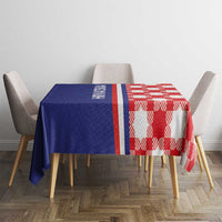 Blue and red checkered tablecloth with white and red border stripes on dining table