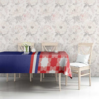 Blue and red checkered tablecloth with central stripe, on dining table with chairs