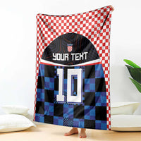 Football jersey blanket, red-white check border, black/blue pixel jersey with 'YOUR TEXT' and 10