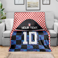 Football jersey blanket, red-white check border, blue/black pixel jersey design with 'YOUR TEXT' 10