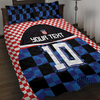 Blue and black checker football jersey quilt set with red gingham border and matching pillowcases.