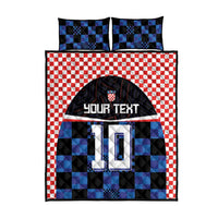 Blue and black checkered football jersey quilt bed set with red gingham trim, includes pillowcases.