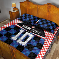 Blue and black football jersey quilt bed set with red gingham border and two matching pillowcases.