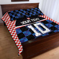 Football jersey quilt bed set with blue and black check pattern and red gingham border on bed.
