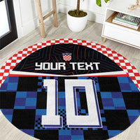 Round football jersey rug with blue and black checkerboard design and crest logo