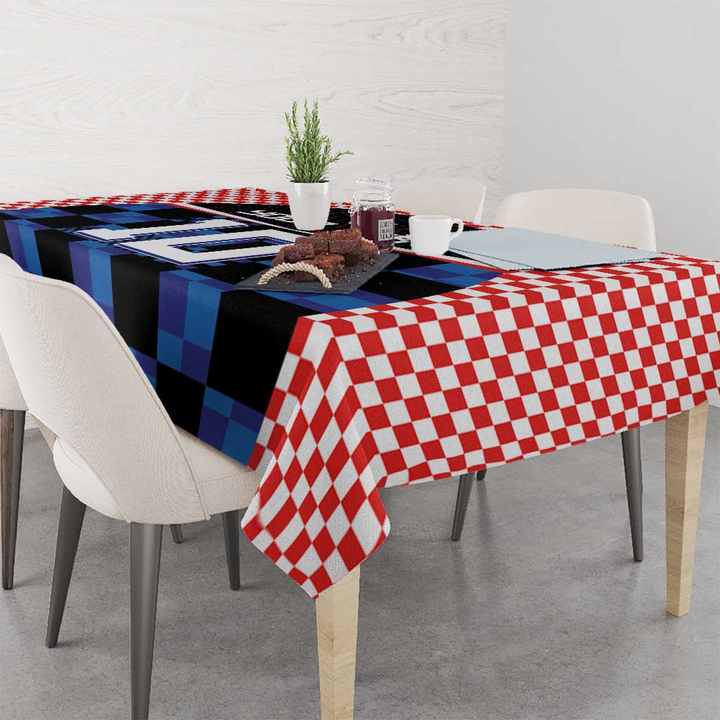 Red and blue football jersey tablecloth with checkered trim draped on dining table