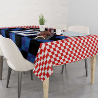 Red and blue football jersey tablecloth with checkered trim draped on dining table